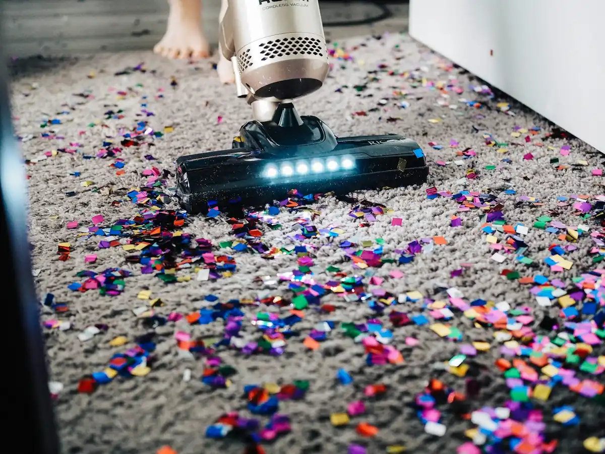 a-person-using-a-vacuum-to-clean-a-carpet.webp